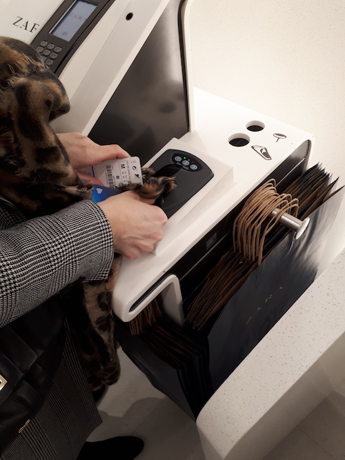 Image of a person scanning their item at a self-service kiosk at the Zara store